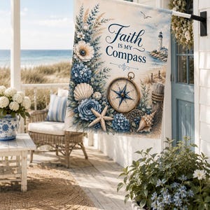 May include: A rectangular garden flag featuring a coastal theme with a lighthouse, a compass, seashells, and blue flowers. The text "Faith IS MY Compass" is printed in dark blue script. The design includes a sandy beach and a fishing net.