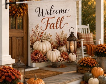 May include: A rectangular garden flag featuring the text Welcome Fall in black and brown script. The design displays white pumpkins, orange flowers, and a lantern on a wood-grain background. The flag is mounted on a black metal pole.