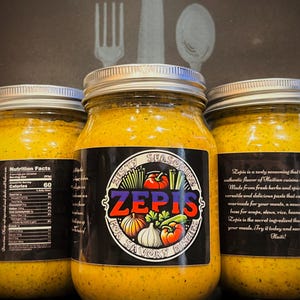 May include: Three glass jars filled with a yellow paste labeled "Zesty Seasoning Zepis for Savory Dishes". The label also includes a nutrition facts panel and a description of the product. The jars are on a dark background.