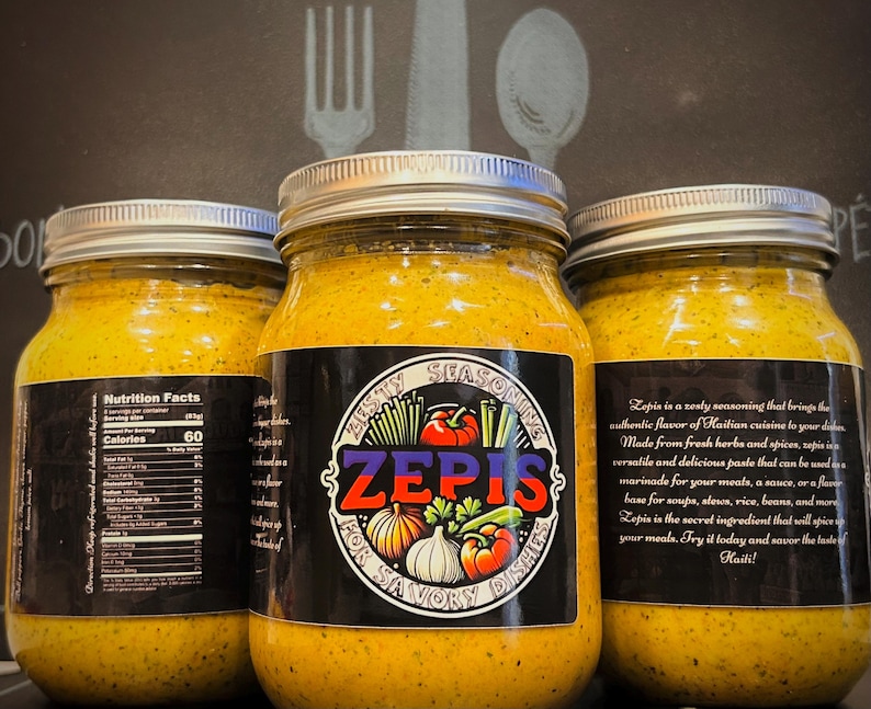 May include: Three glass jars filled with a yellow paste labeled "Zesty Seasoning Zepis for Savory Dishes". The label also includes a nutrition facts panel and a description of the product. The jars are on a dark background.