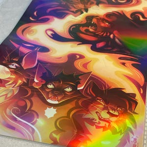 May include: A rectangular holographic art print featuring a vibrant illustration of multiple cats with expressive faces surrounded by swirling orange and yellow flames. The bottom right corner displays the text KATSU-CHI in a stylized font.