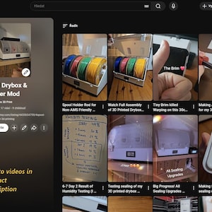 May include: YouTube screenshot featuring a 4-spool drybox and PolyDryer mod for 3D printing. The image shows a white box with multiple spools of filament in various colors. Text on the screen includes "4-Spool Drybox & PolyDryer Mod" and "Link to videos in product description."