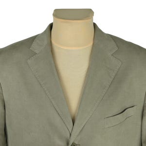 May include: A light green blazer with a notched lapel and a single-breasted design. The blazer has a chest pocket and is displayed on a mannequin. The fabric appears to be a lightweight material.