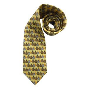 May include: A yellow tie with a repeating pattern of stylized, brown, gray, and orange shapes. The tie is rolled up at the top, showing the pattern on the back. The tie is on a white background.