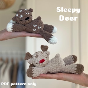 Könnte beinhalten: Zwei gehäkelte Hirschspielzeuge, eines braun mit weißen Akzenten und das andere beige mit einer roten Nase. Die Hirsche liegen mit geschlossenen Augen da, als würden sie schlafen. Der Text "Sleepy Deer" steht über den Hirschen. Der Text "PDF pattern only" steht unter den Hirschen.