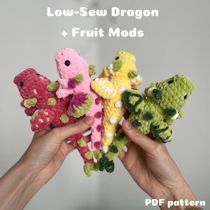 May include: Four crochet dragons in red, pink, yellow, and green, each with fruit-themed details. The image shows the dragons against a plain backdrop. Text at the top reads "Low-Sew Dragon + Fruit Mods", and "PDF pattern" is at the bottom.