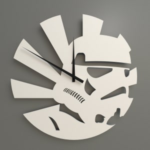 May include: White wall clock with a silhouette of a Star Wars Stormtrooper helmet. The clock face is a sunburst design with black hands.