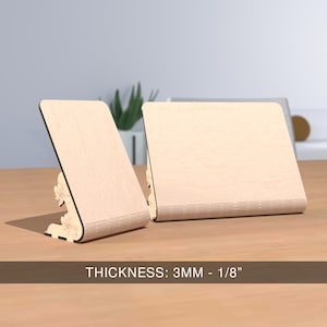 May include: Two wooden picture frames with a decorative design on the bottom. The frames are made of light wood and are 3mm thick, or 1/8 inch.