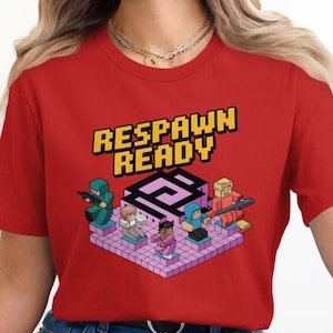 May include: Red t-shirt with the text "RESPAWN READY" in yellow and black block letters. The shirt features a pixelated graphic of several characters on a pink and purple platform, each holding a weapon.