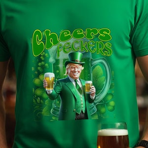 May include: A green t-shirt with a cartoon image of a man wearing a green leprechaun hat and holding two beers. The text "Cheers Feckers" is printed on the shirt.