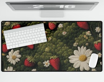 May include: A green and white mousepad with a floral design featuring red strawberries and white daisies. The mousepad is on a white desk with a computer monitor above it.