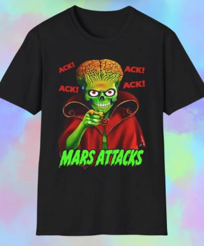 May include: Black t-shirt featuring a green Martian character with a large brain, red eyes, and a red cape. The words "ACK!" are printed in red, and "MARS ATTACKS" is in green, creating a bold graphic design.