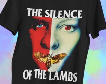 May include: Black t-shirt with a graphic from "The Silence of the Lambs." The design shows a split face, one red and the other white, with a moth and the film's title in white text.