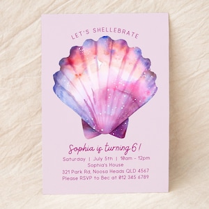 May include: A pink and purple seashell with glitter accents on a light pink background. The text "Let's Shell-ebrate" is at the top of the card. The text "Sophia is turning 6!" is in the centre of the card. The text "Saturday | July 5th | 10am - 12pm" is below the text "Sophia is turning 6!". The text "Sophia's House" is below the text "Saturday | July 5th | 10am - 12pm". The text "321 Park Rd, Noosa Heads QLD 4567" is below the text "Sophia's House". The text "Please RSVP to Bec at 012 345 6789" is below the text "321 Park Rd, Noosa Heads QLD 4567".