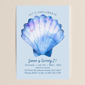 May include: A blue and purple watercolour seashell illustration with the text "LET'S SHELLEBRATE" at the top and "Simon is turning 2!" in the centre. The text below reads "Saturday | July 5th | 10am - 12pm", "Simon's House", "321 Park Rd, Noosa Heads QLD 4567", and "Please RSVP to Bec at 012 345 6789".