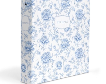 May include: A three-ring binder featuring a white background with a blue floral pattern. The front cover displays a central label with the word RECIPES printed in a clear font. The spine also includes a matching label with the word RECIPES.