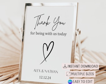 May include: A printable wedding sign with a white background and black text that says "Thank You for being with us today" with a heart symbol and the names "ALEX & NATHAN" and the date "12.12.24". The sign also includes the text "INSTANT DOWNLOAD", "MULTIPLE SIZES", and "EASY TO EDIT".
