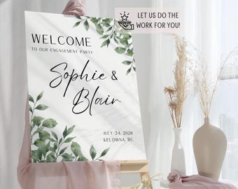May include: White welcome sign with green foliage and the text "Welcome to our engagement party Sophie & Blair July 24, 2028 Kelowna, BC".