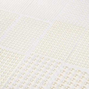 May include: Sheets of adhesive faux pearls in various sizes. The pearls are arranged in neat rows and columns on a white backing. The pearls range in size from tiny dots to larger, teardrop-shaped beads. The overall effect is a delicate, elegant look.