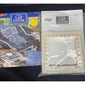 May include: A Square Lap Loom craft kit by Craft House, including a square plastic loom with pegs in a clear plastic bag and an instructional pamphlet featuring a blue and white woven blanket pattern and the text Square Lap Loom, Item #10211.