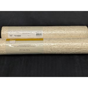 May include: Two rolls of textured off-white wallpaper. Each roll is wrapped in clear plastic and has a label with the product information. The label includes the word "STYLE" and the text "Textured Wallcovering". Each roll is 56 ft (11 yd x 20.5 in).