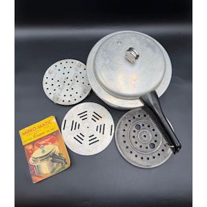 May include: An aluminum Mirro-Matic pressure cooker with a black handle, lid, and various perforated inserts. A recipe booklet is included, featuring the product and the text "Mirro-Matic Pressure Pan Recipes".