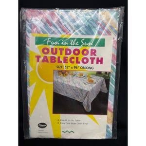 May include: An oblong outdoor tablecloth in a plastic package with a colorful diagonal stripe pattern. The label reads Fun in the Sun OUTDOOR TABLECLOTH SIZE: 52" x 96" OBLONG. It shows a photo of the tablecloth on a table and states it fits 6ft. to 7ft. tables.