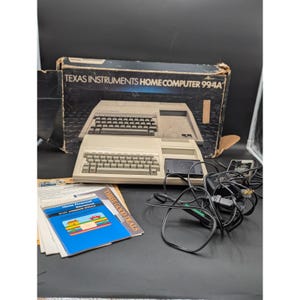 May include: A vintage Texas Instruments Home Computer 994A, with its original box, manuals, and accessories. The beige computer features two keyboards and a cartridge slot. The box reads "Texas Instruments Home Computer 994A".