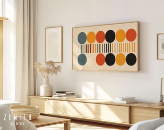 May include: A framed abstract art print with a geometric design of circles and stripes in shades of blue, orange, yellow, and black. The print is hanging on a white wall above a wooden entertainment center.