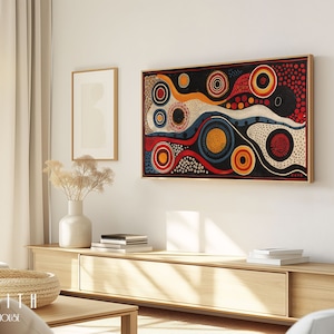 May include: Abstract art print with a black background, featuring colourful circles, dots, and swirls in red, yellow, blue, and white. The print is framed in a thin, wooden frame.