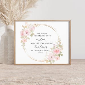 May include: A printable art print with a watercolor floral wreath and a gold circle. The text reads "She opens her mouth with wisdom and the teaching of kindness is on her tongue."  Proverbs 31:26
