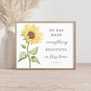 May include: A framed print with a watercolor illustration of a sunflower and the text "He has made everything beautiful in His time - Ecclesiastes 3:11"