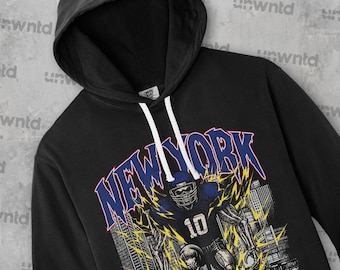 May include: Black hooded sweatshirt with a graphic print of a football player running down a city street with the text "NEW YORK" in blue and yellow.