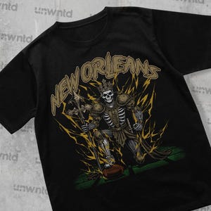 ニューオーリンズ フットボール シャツ - グラフィック T シャツ - スケルトン シャツ - マーチャンダイズ T シャツ - ギフト シャツ - ブートレッグ シャツ - スケルトン フットボール シャツ - セインツ