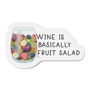 May include: A white sticker with a glass of wine filled with fruit. The text on the sticker reads "Wine is basically fruit salad."