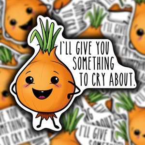 May include: A cartoon onion with a smiling face and green hair says "I'll give you something to cry about." The onion is on a white background with other onion stickers.