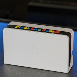 May include: White printer with the words "Pixel Lab Prints" in colorful letters on the top. The printer has a small logo on the front that says "Pixel Lab Prints".