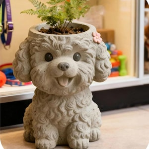 May include: A gray, dog-shaped planter with a happy expression, holding a small green plant. The planter has a pink flower on its head. The dog's fur is textured, and the eyes are dark. A charming decorative item for plant lovers.