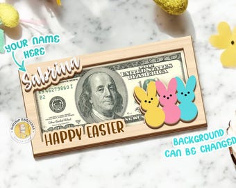 May include: A wooden sign with a dollar bill featuring Benjamin Franklin and the text "Happy Easter". The sign also features three pastel-colored Peeps marshmallow candies and a space for a personalized name. The background is a marble surface with Easter decorations.