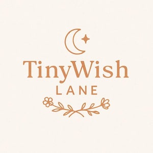 May include: A logo for TinyWish Lane in a warm brown color, featuring a crescent moon and star, the text "TinyWish Lane," and a floral design. The design is on a cream-colored background.