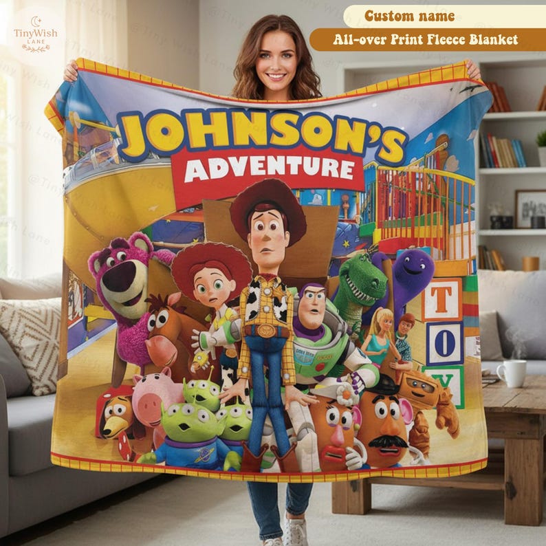 May include: A fleece blanket featuring a colorful Toy Story character print with the text JOHNSON'S ADVENTURE. The design includes Woody, Buzz Lightyear, Jessie, Rex, Slinky Dog, Hamm, Mr. Potato Head, Lotso, and the Aliens on a playground background.