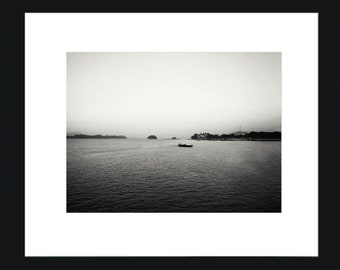 Fotografía en blanco y negro de un barco navegando en el océano.