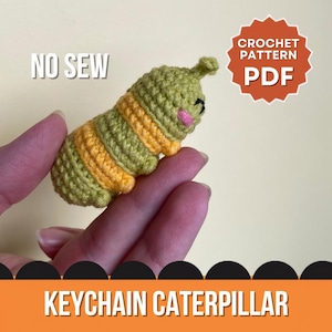 May include: A small crochet caterpillar keychain with alternating olive green and yellow yarn segments. The caterpillar features embroidered black eyes and pink cheeks. Text on the image reads NO SEW, CROCHET PATTERN PDF, and KEYCHAIN CATERPILLAR.