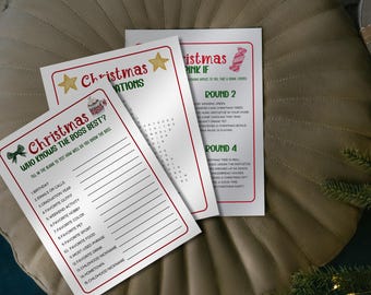 May include: Three Christmas-themed game cards with red borders and festive graphics. The cards feature text like "Christmas Trivia" and "Who Knows the Boss Best?" on a neutral background, suggesting a holiday party game.