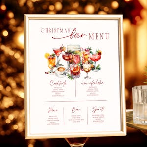 May include: A framed Christmas bar menu with watercolor illustrations of cocktails and drinks. The menu includes sections for cocktails, non-alcoholic beverages, wine, beer, and spirits. The text reads "Christmas Bar Menu."