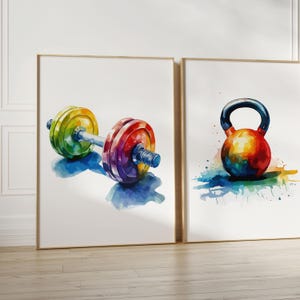 May include: Two framed watercolor paintings of colorful gym equipment. The first painting shows a rainbow-colored barbell with weights. The second painting shows a rainbow-colored kettlebell.