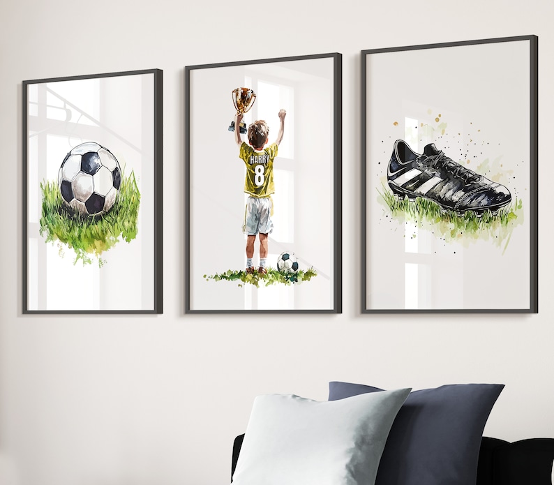 May include: Three framed watercolour paintings depicting a football player holding a trophy, a football, and a football boot. The player is wearing a yellow jersey with the number 8 and the name "Harry" on the back.
