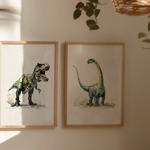 Puede incluir: Dos ilustraciones enmarcadas de dinosaurios. El marco de la izquierda muestra un Tyrannosaurus Rex verde sobre un fondo blanco. El marco de la derecha muestra un Brachiosaurus verde sobre un fondo blanco.