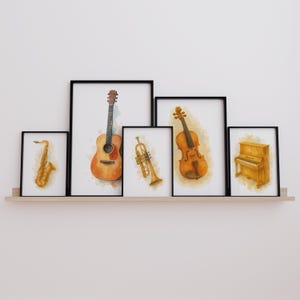 May include: A set of framed watercolour art prints showcasing musical instruments. The prints depict a saxophone, guitar, trumpet, violin, and piano. Each instrument is rendered in warm, earthy tones, set against a white backdrop, and framed in black.