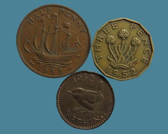 May include: Three British coins from 1952: a half penny with a ship, a three pence with a flower design, and a farthing with a wren.